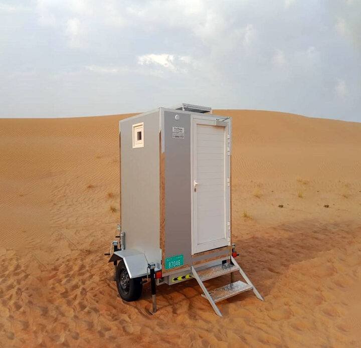 trailer or caravan portable toilet in the middle of desert